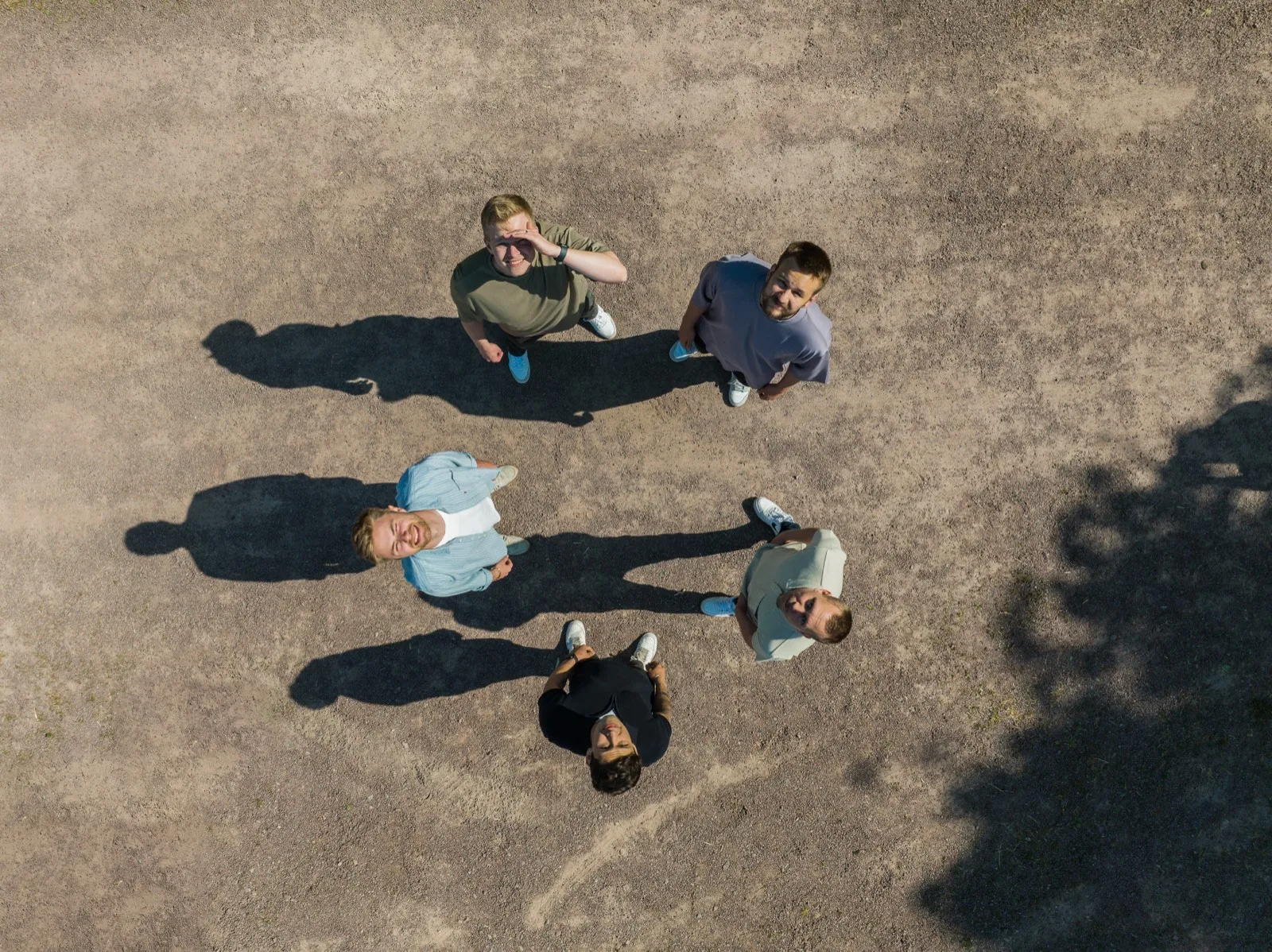 Five Flowbic colleagues photographed from above, outdoors in the sun